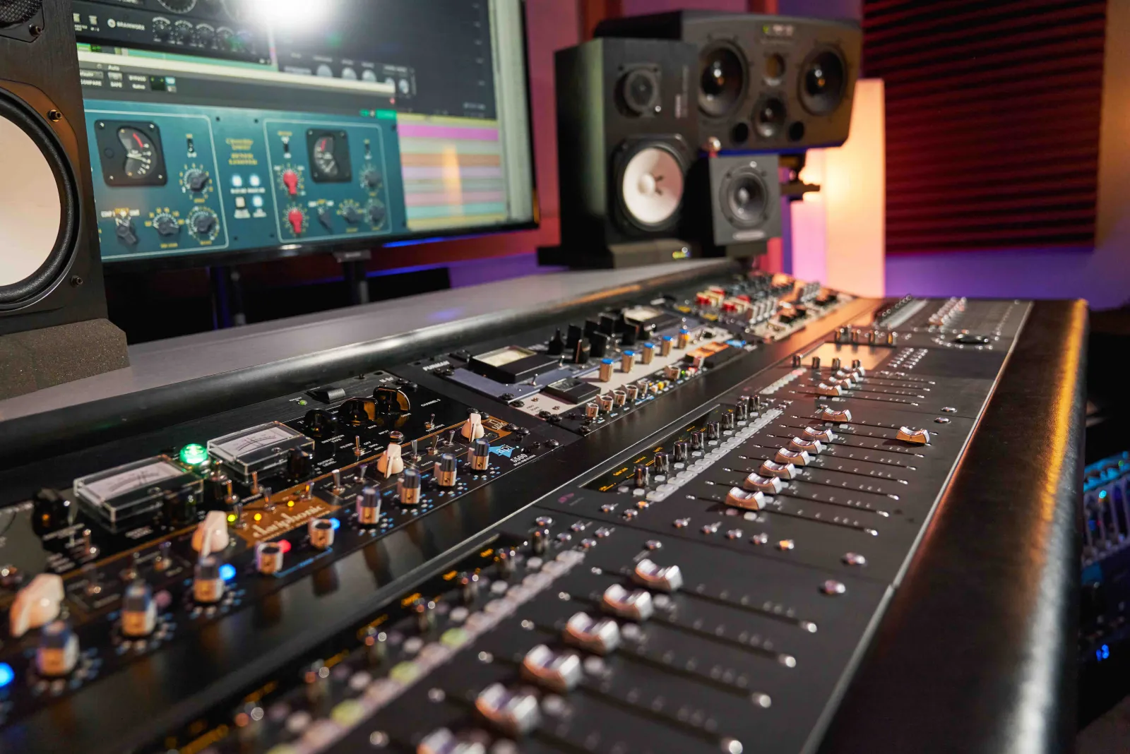 Analog console controls used for detailed mixing